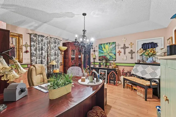 a living room with furniture and a chandelier