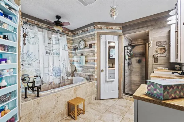 a spacious bathroom with a tub shower and a sink