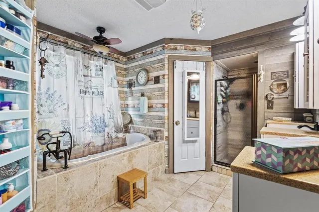 a spacious bathroom with a tub shower and a sink