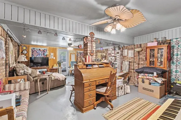 a room with lots of wooden furniture and a chandelier