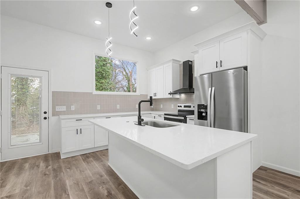 1667 Thornton Place Southwest Atlanta, GA 30315 - Photo 13 of 41 a kitchen with stainless steel appliances a sink a stove a refrigerator and cabinets