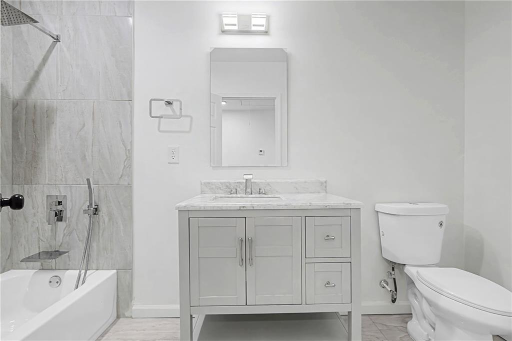 1667 Thornton Place Southwest Atlanta, GA 30315 - Photo 23 of 41 a bathroom with a sink a toilet and shower