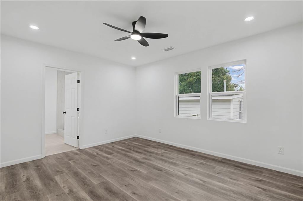 1667 Thornton Place Southwest Atlanta, GA 30315 - Photo 28 of 41 an empty room with a window and a ceiling fan