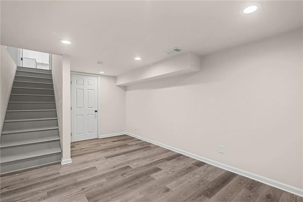 1667 Thornton Place Southwest Atlanta, GA 30315 - Photo 34 of 41 a view of hallway with stairs and wooden floor