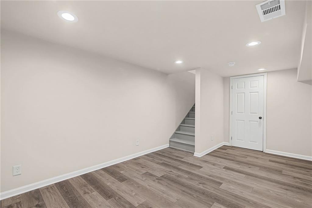 1667 Thornton Place Southwest Atlanta, GA 30315 - Photo 35 of 41 a view of an empty room with wooden floor and stairs