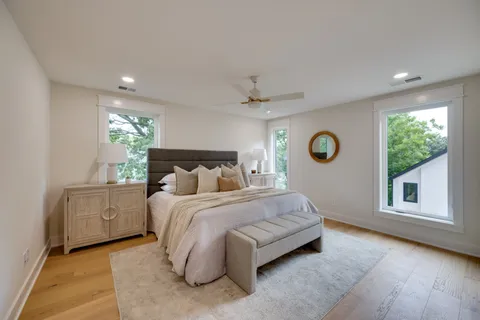 a spacious bedroom with a bed and a window