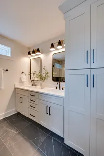 a spacious bathroom with a double vanity sink and mirror