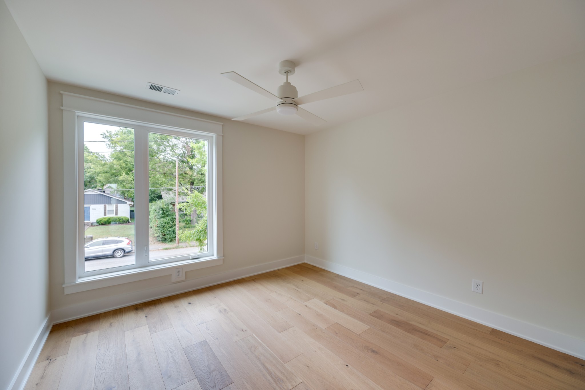 704 Stockell Street Nashville, TN 37207 - Photo 17 of 32 an empty room with wooden floor and windows