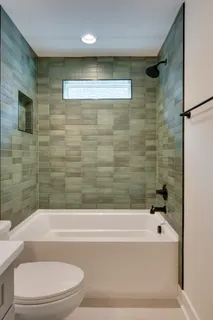 a bathroom with a bathtub and a shower