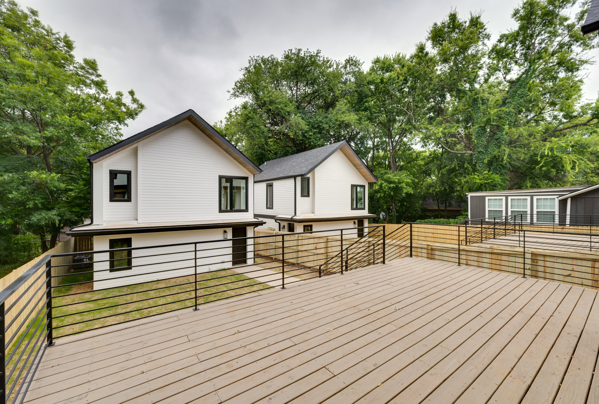 704 Stockell Street Nashville, TN 37207 - Photo 22 of 32 a view of house with deck outdoor seating and covered with trees in the background