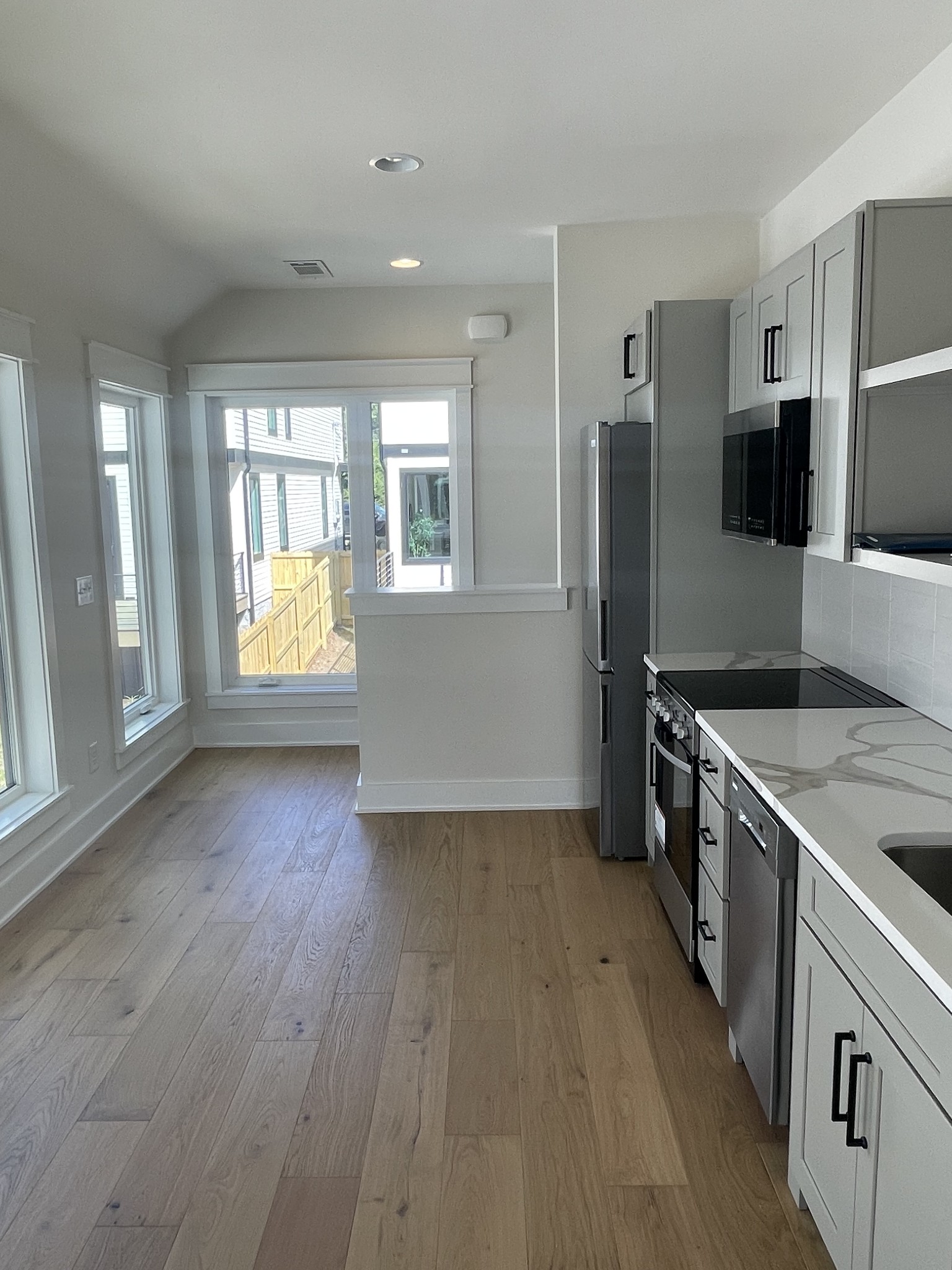 704 Stockell Street Nashville, TN 37207 - Photo 26 of 32 a kitchen with stainless steel appliances granite countertop a refrigerator a stove and a wooden floors