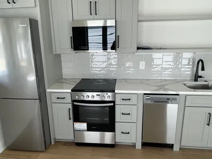 a kitchen with stainless steel appliances granite countertop a stove and a refrigerator
