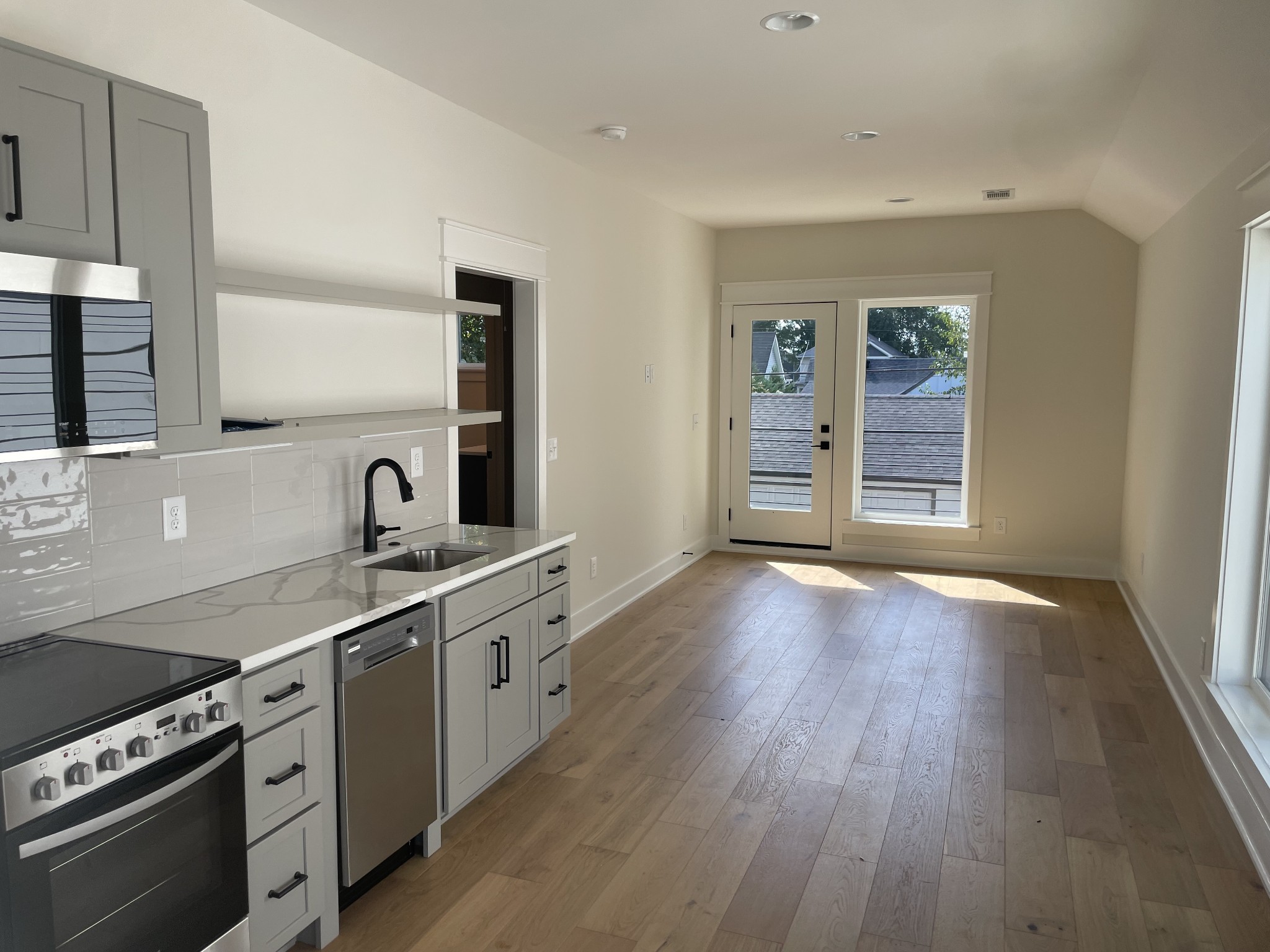 704 Stockell Street Nashville, TN 37207 - Photo 28 of 32 a kitchen with stainless steel appliances granite countertop a sink stove and wooden floor