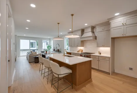 a kitchen with sink cabinets and wooden floor
