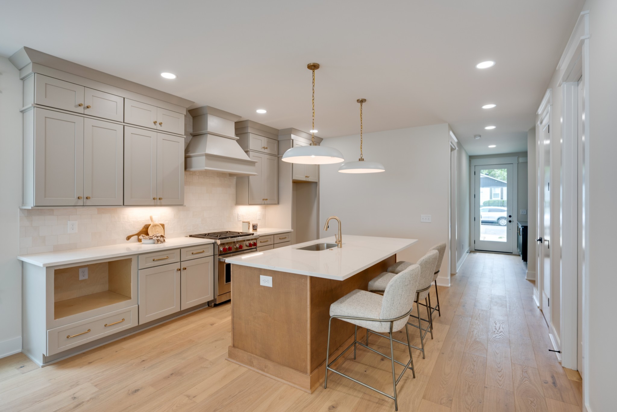 704 Stockell Street Nashville, TN 37207 - Photo 5 of 32 a kitchen with stainless steel appliances kitchen island granite countertop a stove a sink a refrigerator and a dining table with wooden floor