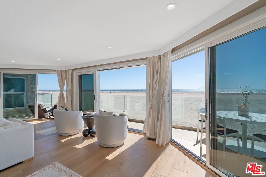 3521 Ocean Drive Oxnard, CA 93035 - Photo 11 of 53 a living room with furniture a large window and a wooden floor