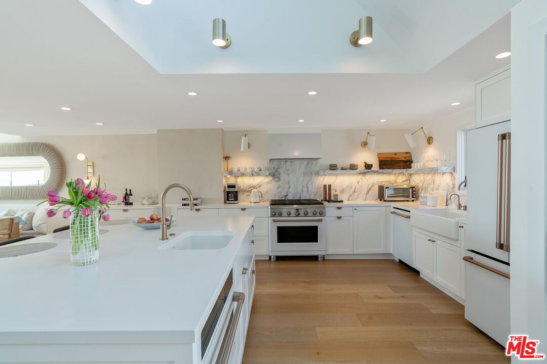 3521 Ocean Drive Oxnard, CA 93035 - Photo 15 of 53 a kitchen with kitchen island a sink appliances cabinets and a counter top space