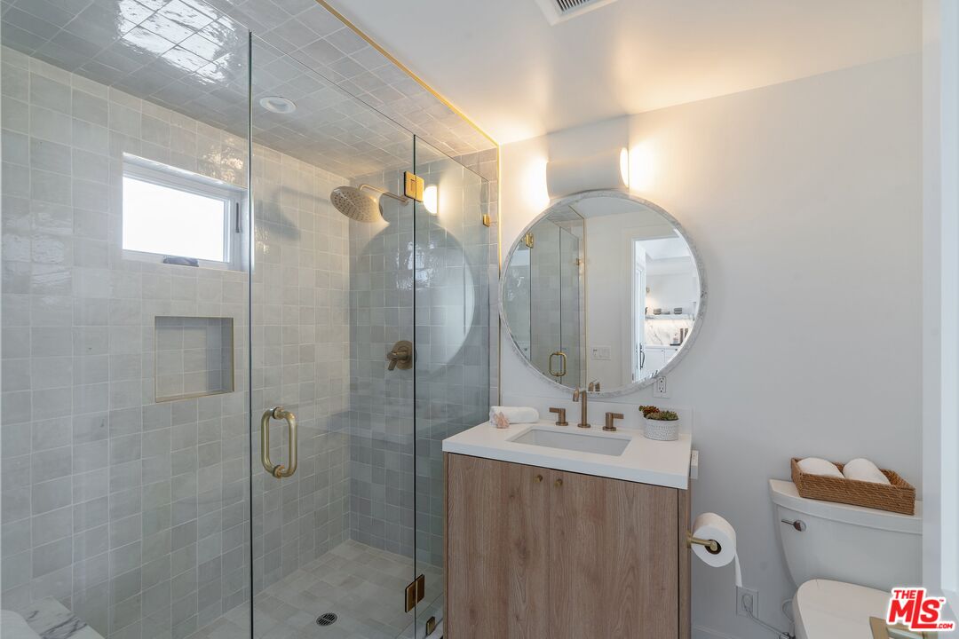 3521 Ocean Drive Oxnard, CA 93035 - Photo 16 of 53 a bathroom with a double vanity sink mirror and toilet