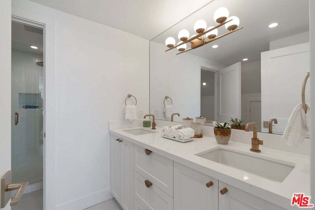 3521 Ocean Drive Oxnard, CA 93035 - Photo 27 of 53 a bathroom with a sink a large mirror and vanity