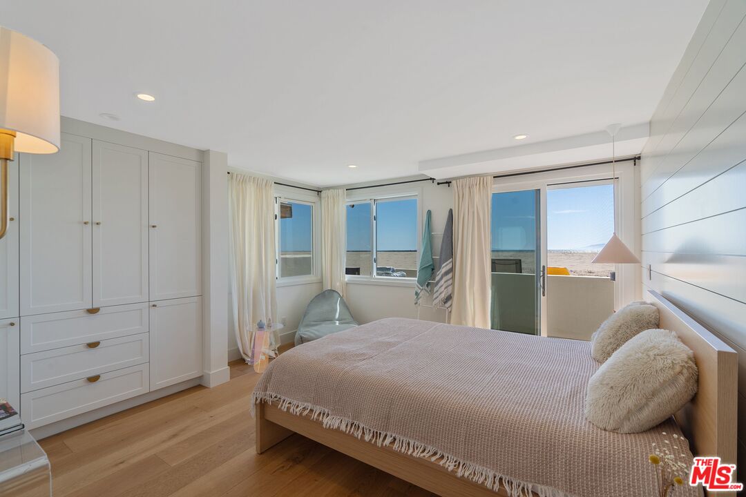 3521 Ocean Drive Oxnard, CA 93035 - Photo 31 of 53 a bedroom with a bed and a lamp