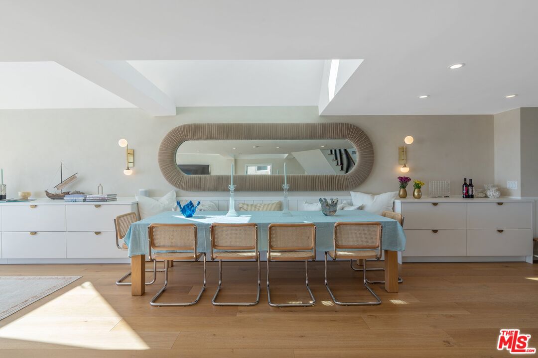 3521 Ocean Drive Oxnard, CA 93035 - Photo 8 of 53 a view of a kitchen with granite countertop a dining table chairs and a wooden floor