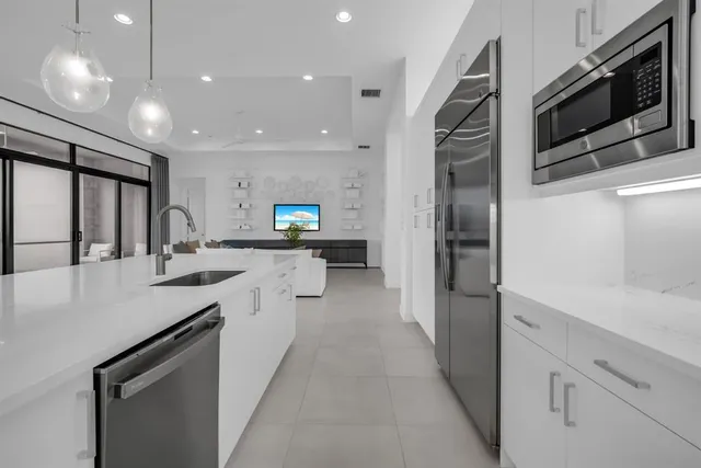 a large white kitchen with a large window