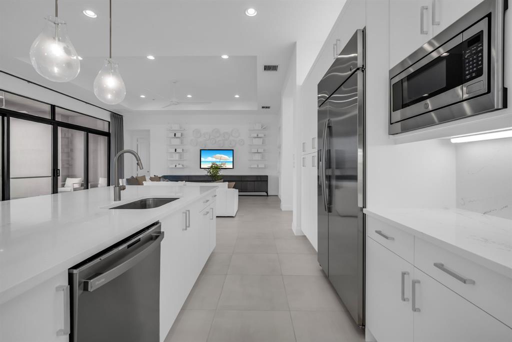 11242 Gln Orch Lane Boynton Beach, FL 33473 - Photo 11 of 55 a large kitchen with stainless steel appliances a sink and a refrigerator