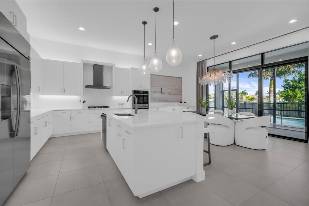 11242 Gln Orch Lane Boynton Beach, FL 33473 - Photo 12 of 55 a large white kitchen with a large window