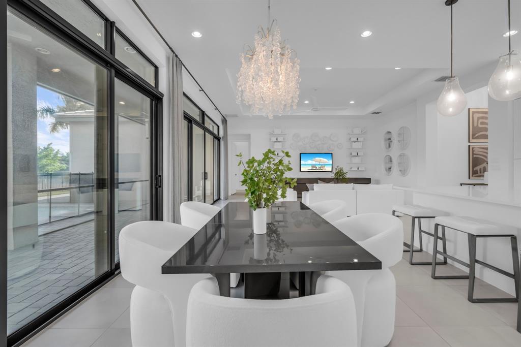 11242 Gln Orch Lane Boynton Beach, FL 33473 - Photo 14 of 55 a kitchen with stainless steel appliances a dining table chairs and couches