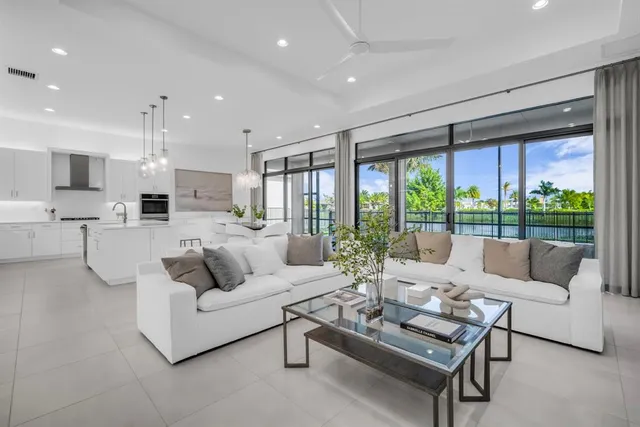 a kitchen with stainless steel appliances kitchen island granite countertop a sink and a refrigerator