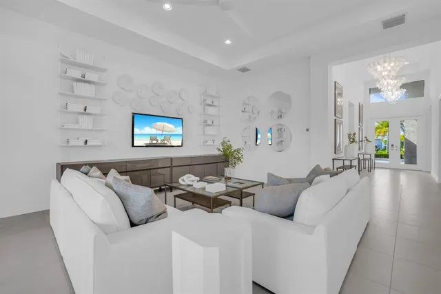 a bedroom with a bed and a flat tv screen on dresser