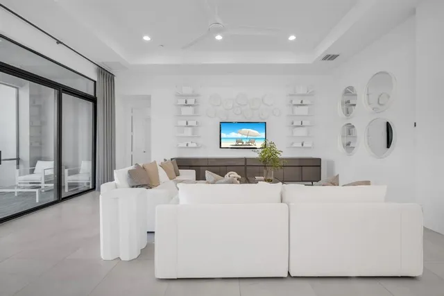 a spacious bedroom with a bed and a flat screen television