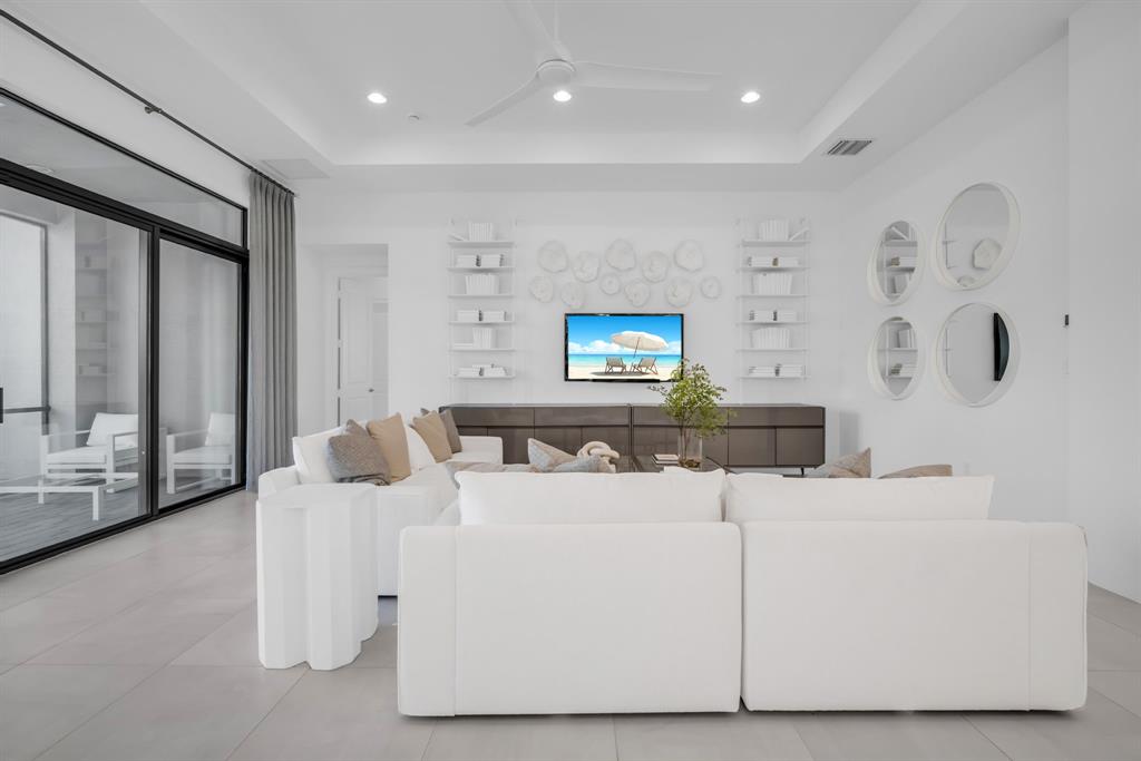 11242 Gln Orch Lane Boynton Beach, FL 33473 - Photo 22 of 55 a living room with furniture and a flat screen tv