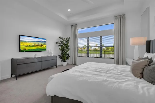a bed sitting in a bedroom next to a window