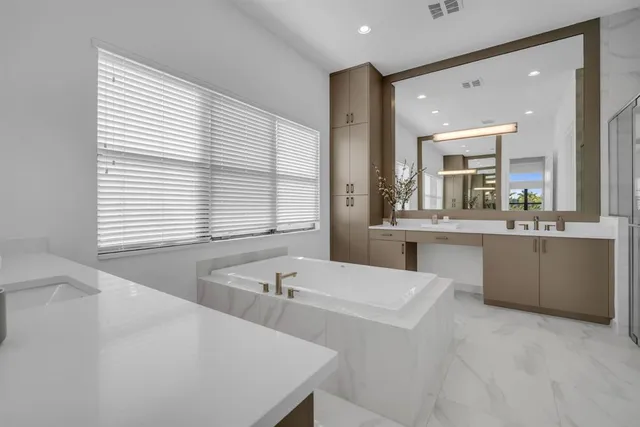 a bathroom with a double vanity sink and mirror