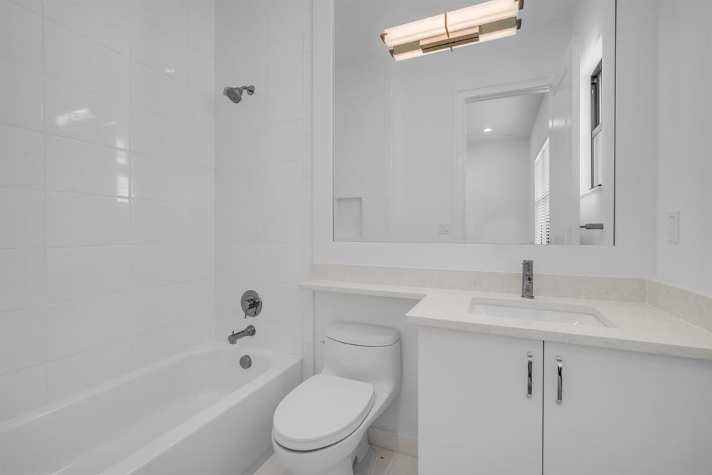 11242 Gln Orch Lane Boynton Beach, FL 33473 - Photo 32 of 55 a bathroom with a bathtub shower sink vanity and toilet