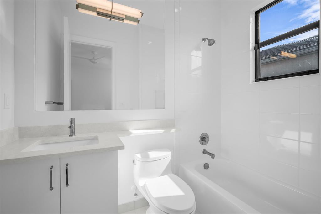 11242 Gln Orch Lane Boynton Beach, FL 33473 - Photo 36 of 55 a bathroom with a sink a toilet and shower