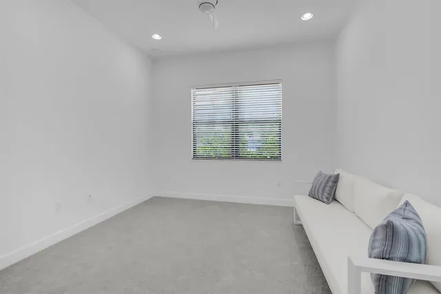 a kitchen with white cabinets and sink