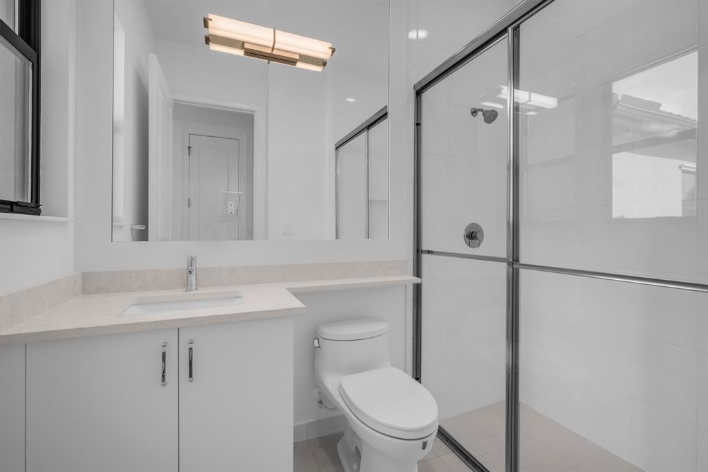 11242 Gln Orch Lane Boynton Beach, FL 33473 - Photo 39 of 55 a bathroom with a toilet sink vanity and shower