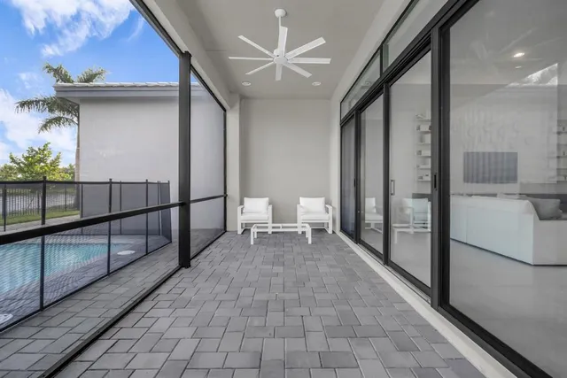 a front view of a house with a garden and trees