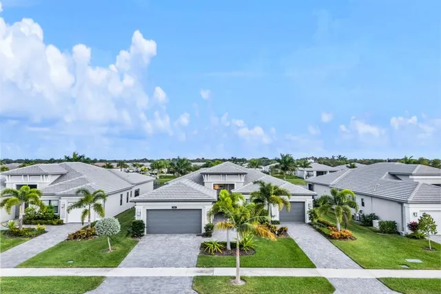 an aerial view of a house with a pool yard and outdoor seating