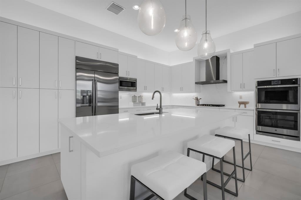 11242 Gln Orch Lane Boynton Beach, FL 33473 - Photo 8 of 55 a kitchen with stainless steel appliances a refrigerator and microwave
