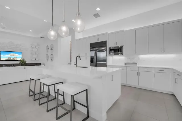 a kitchen with white cabinets and white appliances