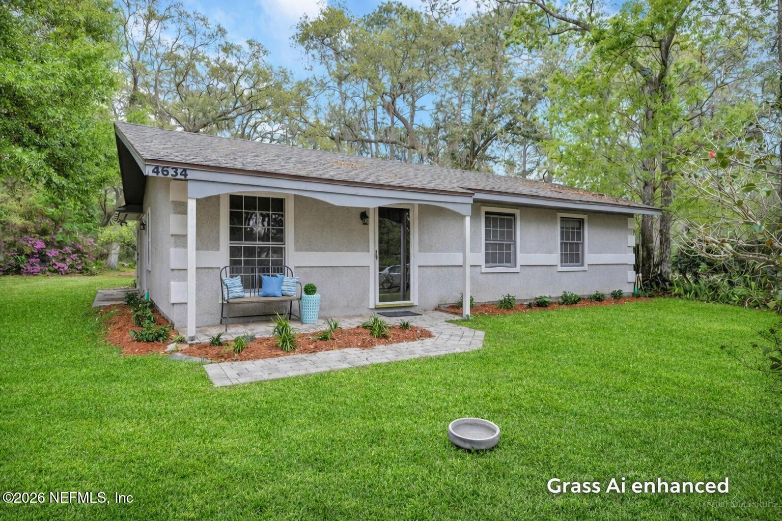 4634 Whimbrel Lane Fernandina Beach, FL 32034 - Photo 1 of 42 a backyard of a house with table and chairs