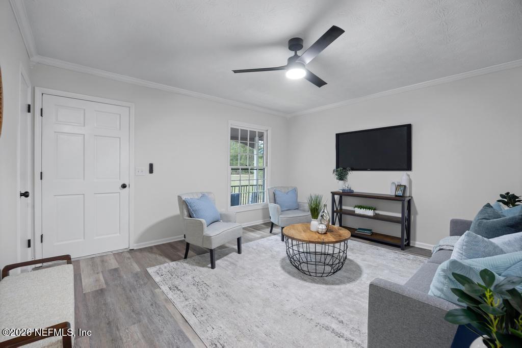 4634 Whimbrel Lane Fernandina Beach, FL 32034 - Photo 11 of 42 a living room with furniture and a flat screen tv