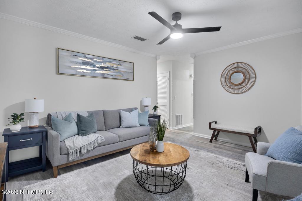 4634 Whimbrel Lane Fernandina Beach, FL 32034 - Photo 12 of 42 a living room with furniture and a clock