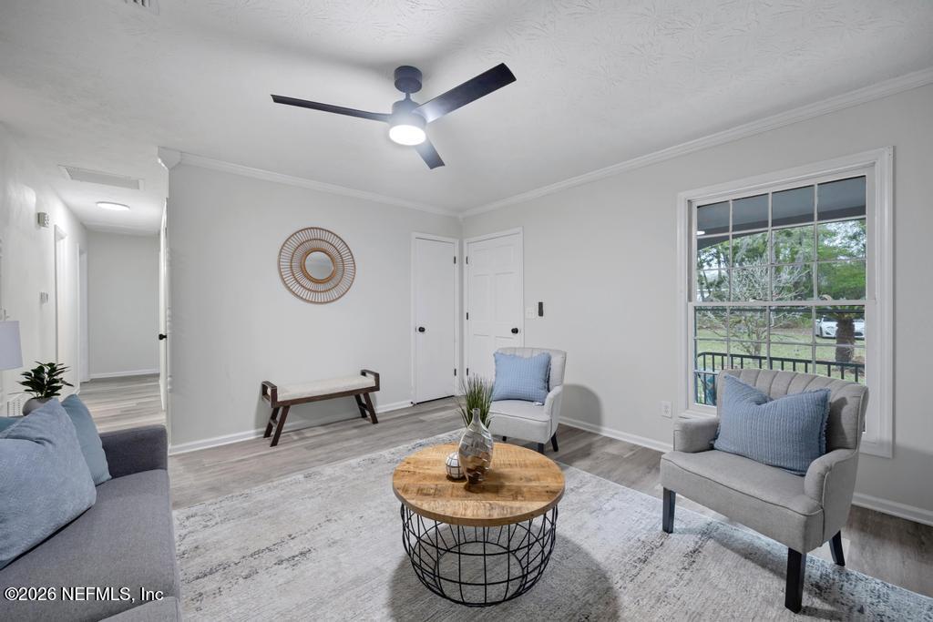 4634 Whimbrel Lane Fernandina Beach, FL 32034 - Photo 13 of 42 a living room with furniture and a large window