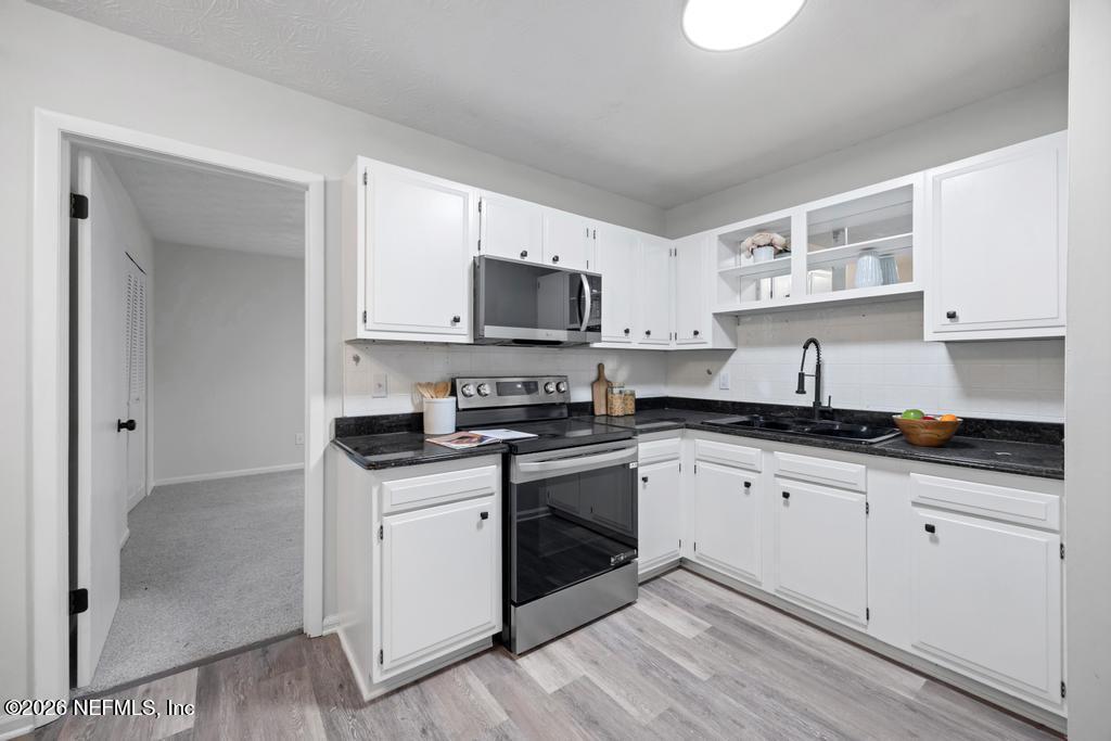 4634 Whimbrel Lane Fernandina Beach, FL 32034 - Photo 15 of 42 a kitchen with stainless steel appliances granite countertop a sink and cabinets