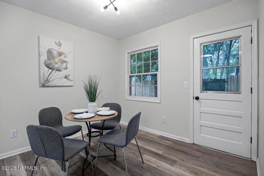 4634 Whimbrel Lane Fernandina Beach, FL 32034 - Photo 17 of 42 a view of a dining room with furniture window and wooden floor