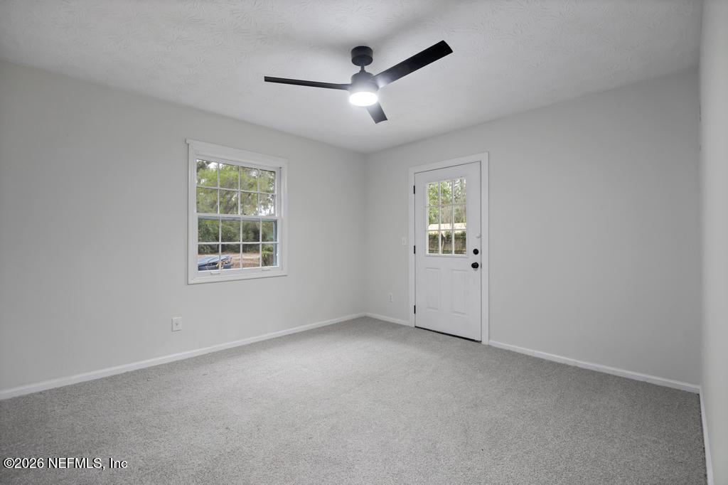 4634 Whimbrel Lane Fernandina Beach, FL 32034 - Photo 20 of 42 an empty room with windows and ceiling fan